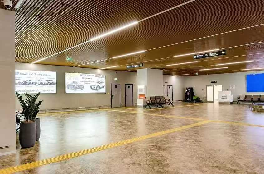 Straight LED linear lights in airport departure hall ceiling
