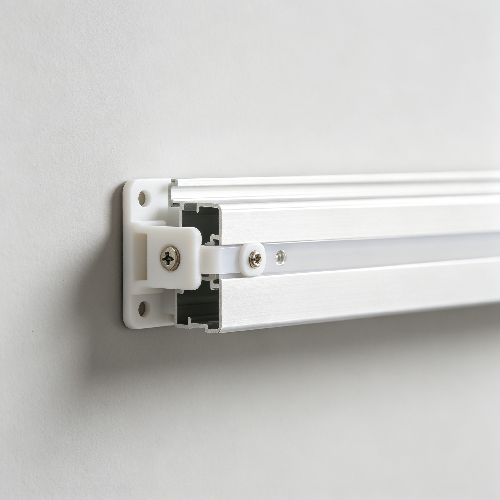 White plastic mounting clip holding LED aluminum channel to wall