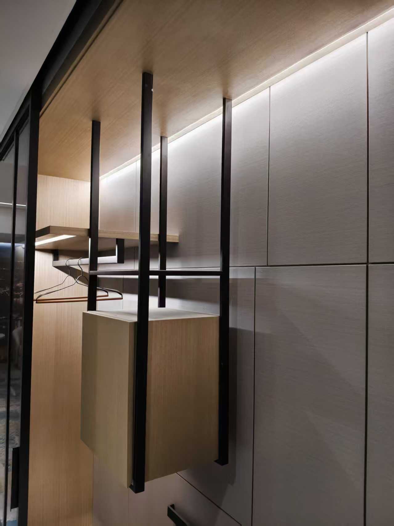 Hidden LED strip light at the top of a wardrobe cabinet