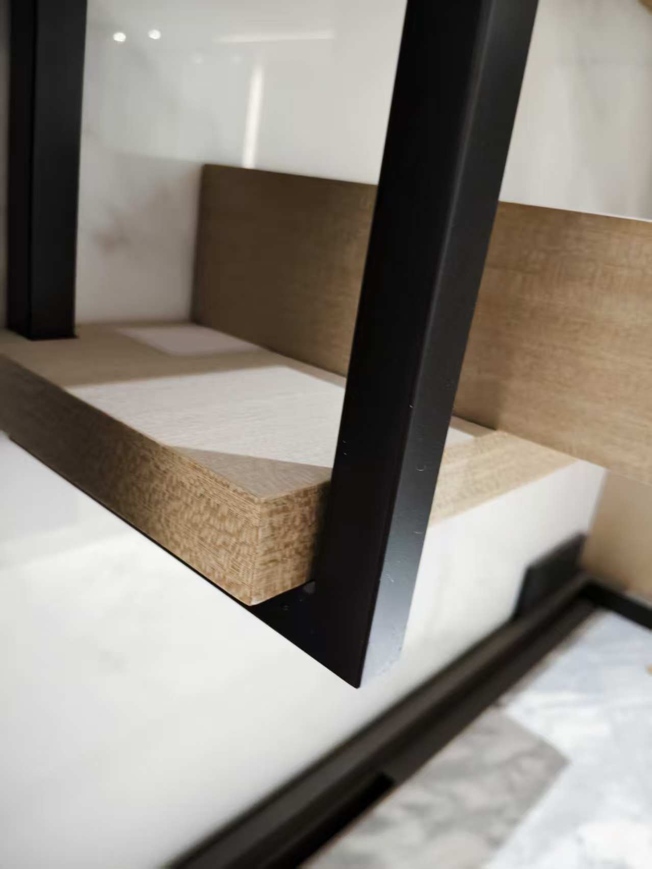 Cabinet construction detail with metal post and wooden shelf
