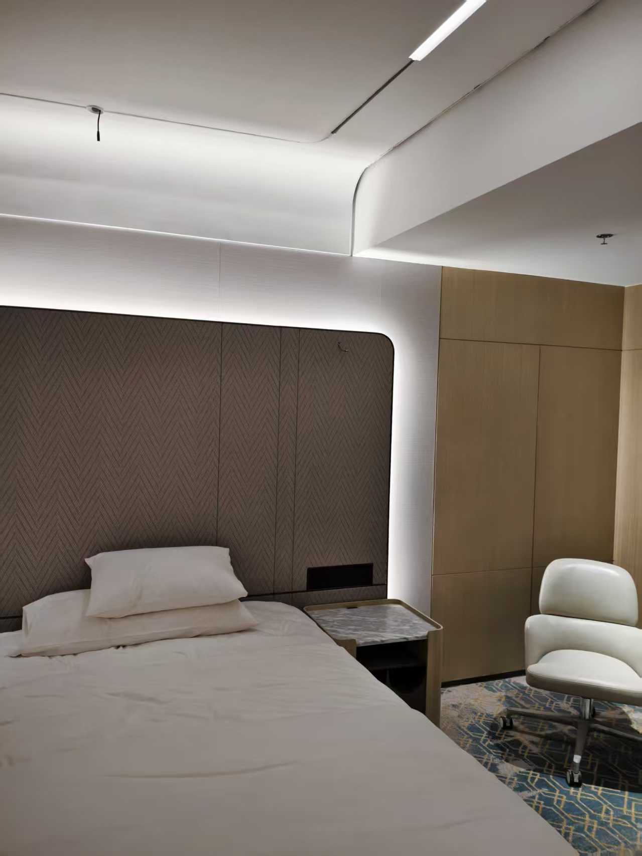 Hotel bedroom with headboard LED strip and ceiling linear light
